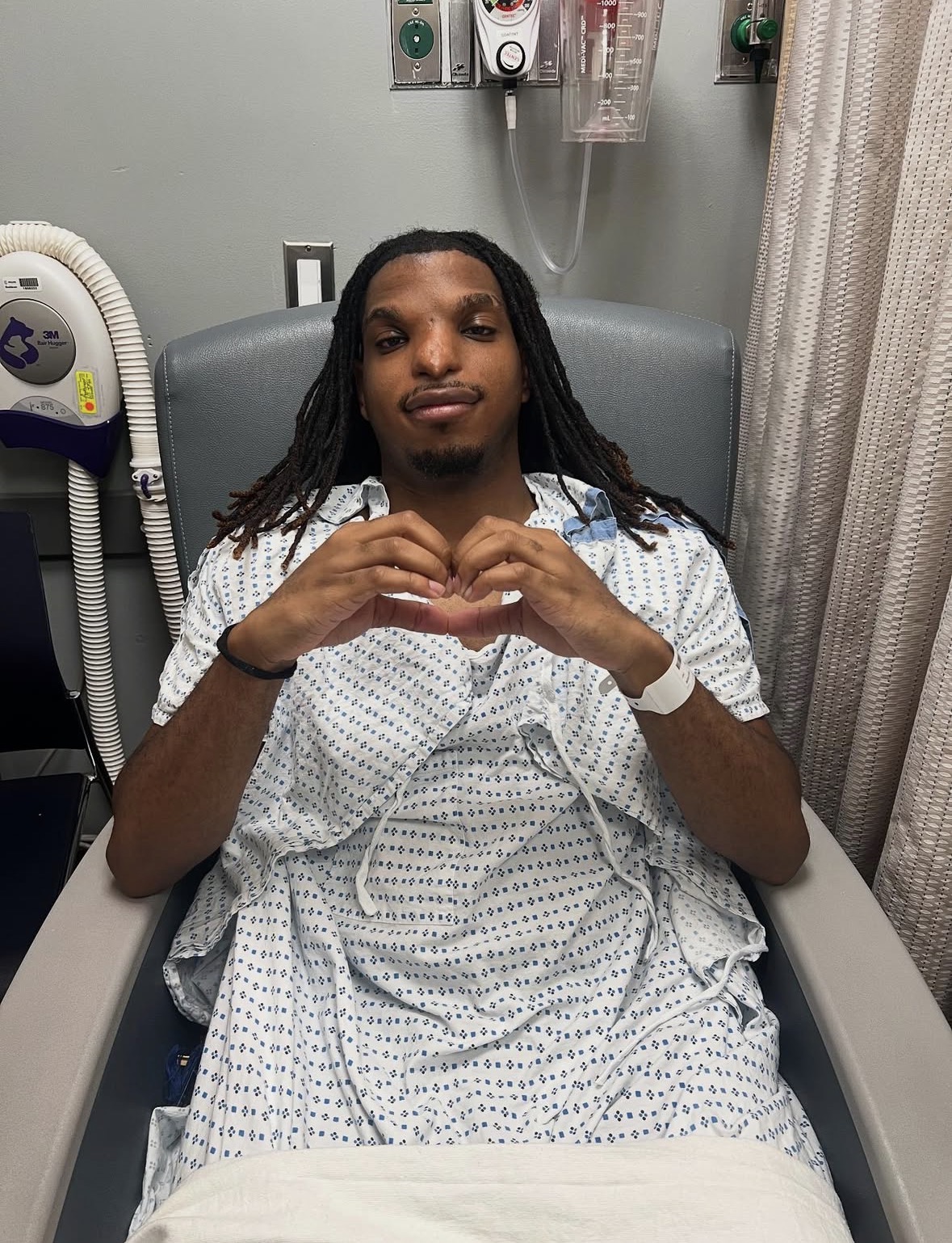 Patient making heart shape with hands